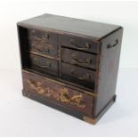 A late 19th century Japanese miniature table-chest (minus sliding door); lacquered and gilded; six