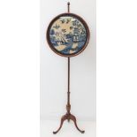 A late 19th to early 20th century mahogany pole-screen: framed and glazed adjustable circular