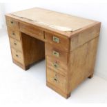 A late 19th century stained-wood pedestal desk: Rexine-inlaid top with a single full-width drawer (