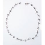 A hallmarked silver necklace of curved and ball link construction (41cm long, boxed)