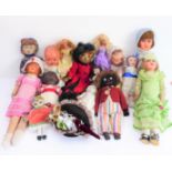 Fifteen collector's dolls to include composition dolls and a bear dressed in long red coat with