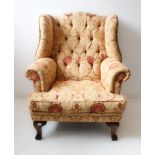 An upholstered buttonback wing-backed armchair in early 18th century style (modern reproduction)