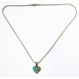 A silver mounted heart-shaped pendant mounted with turquoise upon a silver neck chain and in