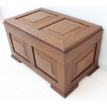 A mid-20th century teak chest of small proportions: hinged lid with two fielded panels; panelled