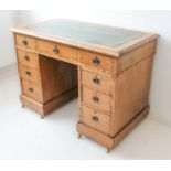 An early 20th century oak pedestal desk: the leather inset gilt-tooled writing surface above an
