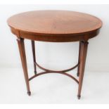 An Edwardian mahogany oval centre table: satinwood crossbanded and boxwood-strung; bow-fronted