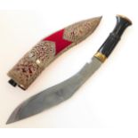 A modern kukri and white-metal-mounted Saudi-style red-felt sheath: heavy carved handle with brass