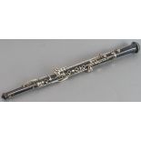 An Italian ebony or ebonised oboe with silvered keywork: maker's name J.M. Grassi - Milano