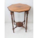 An early 20th century octagonal-topped occasional table on turned legs united by a cruciform