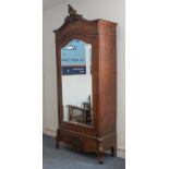 A late 19th to early 20th century French walnut armoire: the top cresting carved in high rocaille