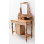 An early 20th century mirror-topped pine dressing-table: small central drawer to mirrored