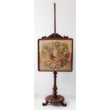 An early Victorian mahogany pole screen; the needlework depicting exotic birds amongst flowers.