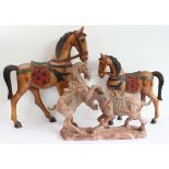Two hand-carved painted wooden ornamental horses (the larger 61 x 51.5 cm) and a terracotta model of
