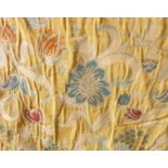 A pair of heavy, yellow curtains with medieval-style floral design from Mulberry and Pierre Frey;