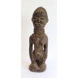 A carved hardwood African-style female figure, probably mid-20th century (43 cm high)