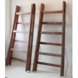 A pair of early 20th century faded pink painted pine trestles with horizontal bars (each approx.
