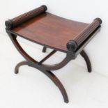 A Regency mahogany X-frame stool: the slightly concave, solid seat with reeded and turned columnar