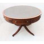 A Regency-style (good later modern reproduction) mahogany drum table: the circular green leather