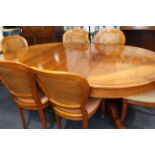 A Grange extendable cherrywood dining table and a matching set of six chairs. The oval-ended table