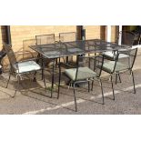 A modern black-painted metal garden table, six chairs and parasol stand. The six-seater table with