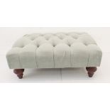 A modern light-green pouffe or footstool (74 x 50 x 29 cm)