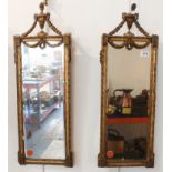 A pair of gilt-framed vertical wall-hanging looking glasses of rectangular section and in late
