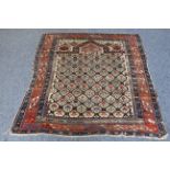An early/mid 20th century Caucasian Dagestan prayer rug: central beige ground and varying sized red,