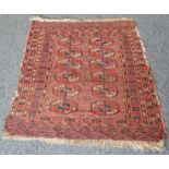A mid 20th century Tekke Turkmen/Turkoman carpet: red ground and with 12 guls to the central