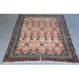 A 19th century hand-knotted Khotan rug (Eastern Turkistan): stylised flowerheads including turquoise