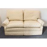 A good modern cream-coloured upholstered two-seater sofa decorated with floral sprigs (175 x 82 x 94