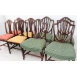 A set of four late 18th century Hepplewhite period shield-backed mahogany dining chairs; the