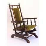 A late 19th century American style stained beech child's rocking chair: the turned frame with