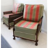 A pair of early 20th century mahogany-framed bergère chairs, each with caned back, double caned