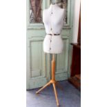 A 1960s-70s tailor's or dressmaker's adjustable mannequin: on a beechwood tripod base, 136cm high.