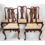 A set of five (4 + 1) early 18th century style walnut dining chairs each with vase-shaped pierced