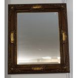 A gilt-framed wall-hanging looking glass in 19th century style and with hand-bevelled plate, a