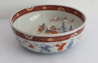 A 19th century Japanese porcelain bowl: the interior decorated with four cranes in flight above four