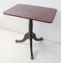 An early 19th century rectangular-topped mahogany tilt-top occasional table; turned stem and on