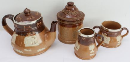 Five pieces of Doulton with similar applied decoration: 1. A stoneware three-piece tea set with