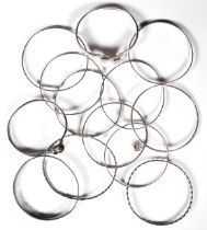 A collection of silver bangles - including a torc style bangle set with two cabochon moonstones; a