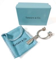 A genuine Tiffany & Co. silver key ring modelled as a champagne bottle hanging from a U-shaped