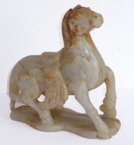 Qing Dynasty (1644-1911) - a large and heavy pale-celadon and russet jade carving of a saddled horse