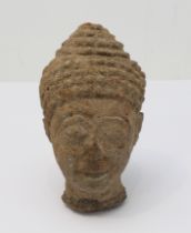 A Thai carved stone Buddha head: believed to be 18th century Ayutthaya period; the face with