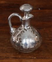 A late 19th/early 20th century silver overlay jug and stopper: the flowerhead-decorated stopper