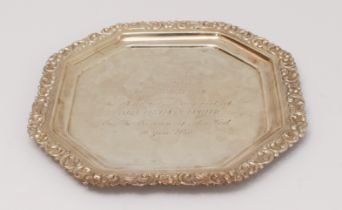 An octagonal white metal presentation salver (marked 'Silver' to underside): floral style repoussé