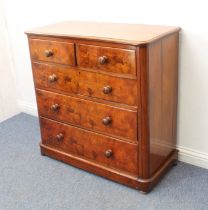 A Victorian mahogany and figured walnut straight front chest of drawers: the moulded top over two
