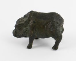 A patinated Chinese bronze model of a wild boar standing four square and with his curled tail angled