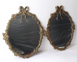 A pair of gilt-brass and gilt-metal oval mirrors in the 18th century style: second half 20th