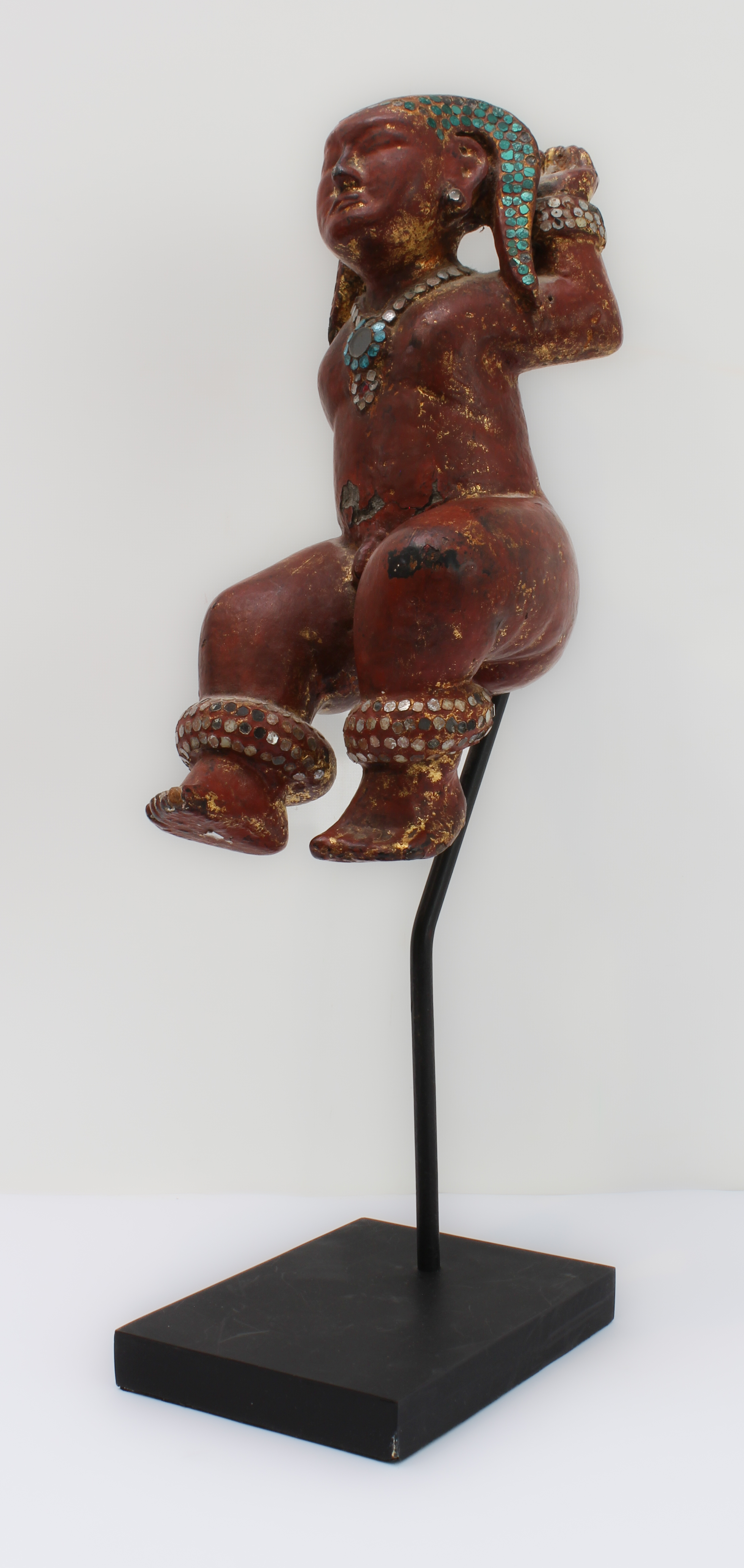 A Burmese wood and red lacquer jewelled figure of a deity: probably late 19th or early 20th century,