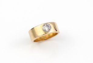 A modernist-style 18ct yellow gold and diamond single stone ring - marked '18CT', the broad band